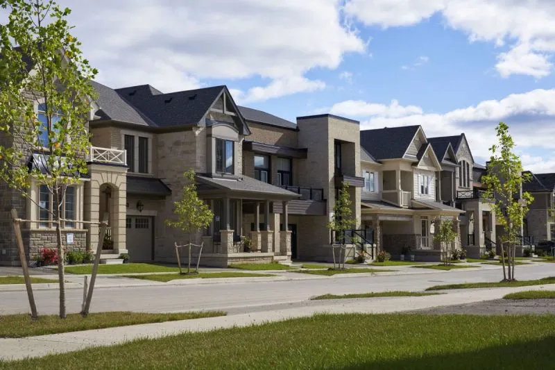 Streetscape of detached homes and front lawns at Upper Joshua Creek, Oakville